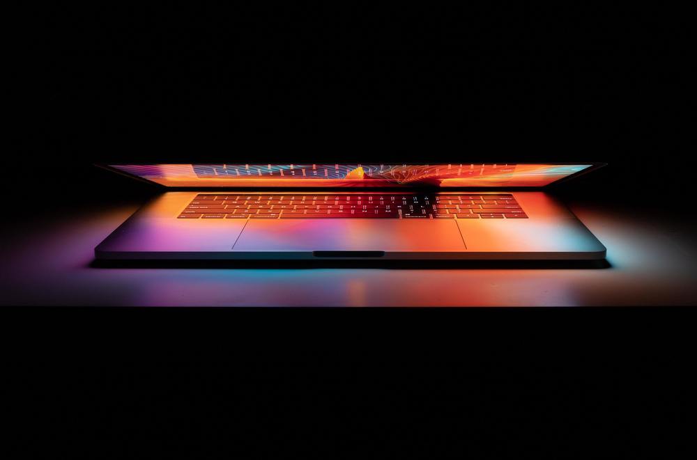 a computer with light coming from the screen